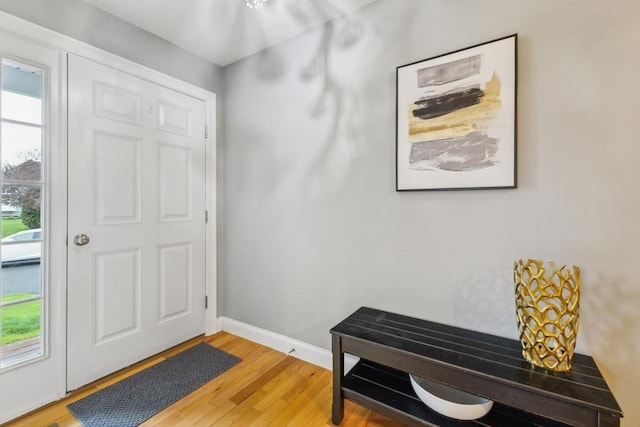 entryway with baseboards and light wood-style flooring