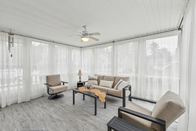 sunroom / solarium featuring wood finished floors