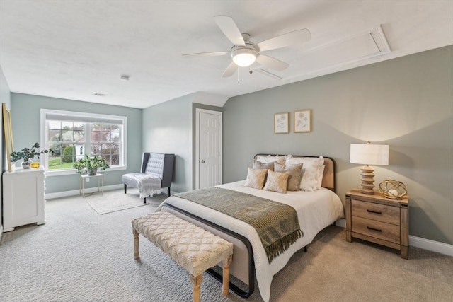 carpeted bedroom with baseboards, a ceiling fan, and attic access