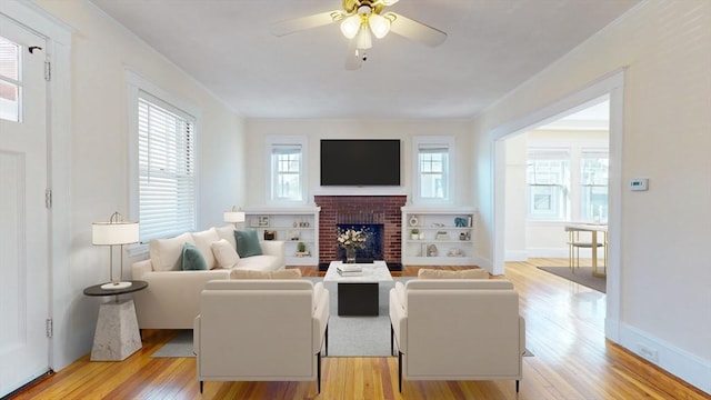 living area featuring a brick fireplace, ornamental molding, and light wood finished floors