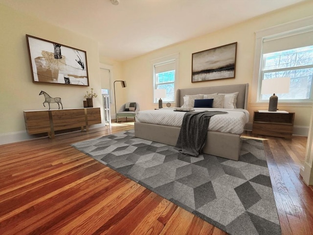 bedroom with baseboards and wood-type flooring