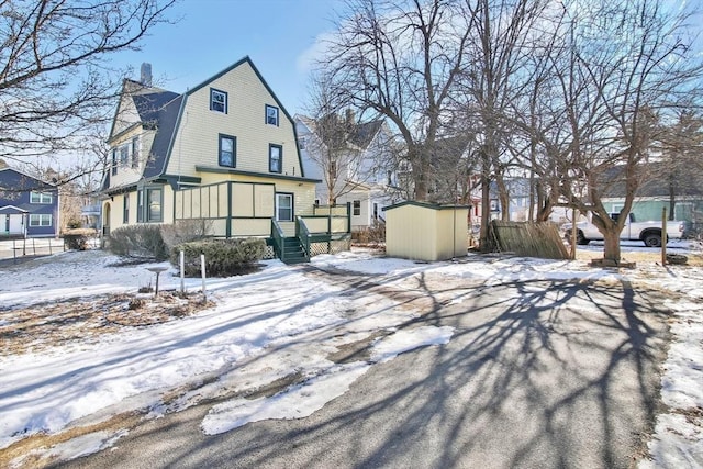 view of front of house featuring a storage shed