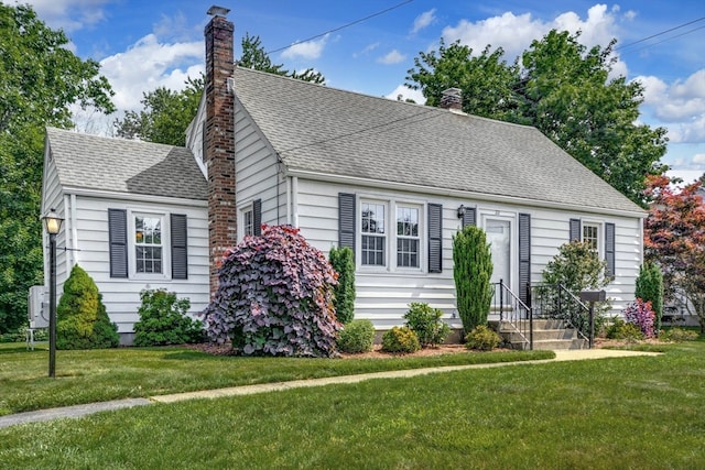 new england style home with a front yard