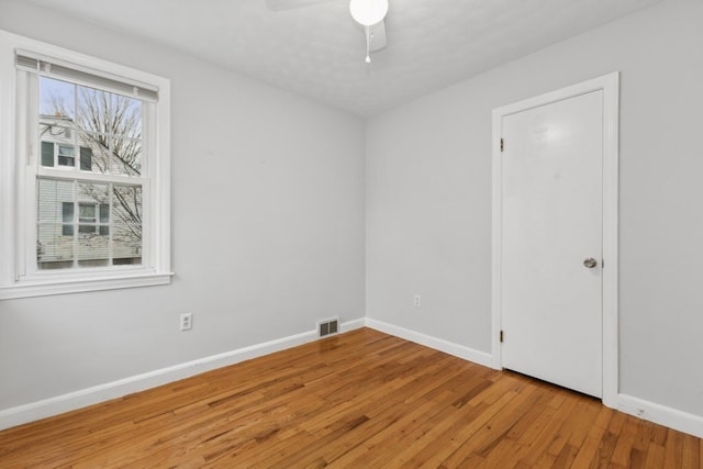 spare room featuring ceiling fan and light hardwood / wood-style floors