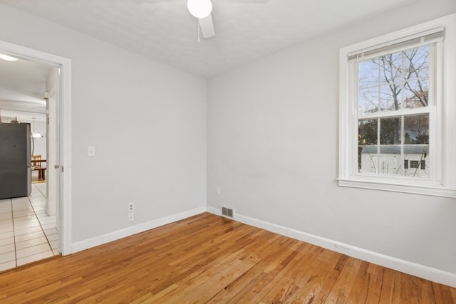 empty room with light hardwood / wood-style floors and ceiling fan