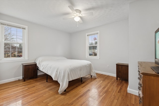 bedroom with ceiling fan and light wood-type flooring