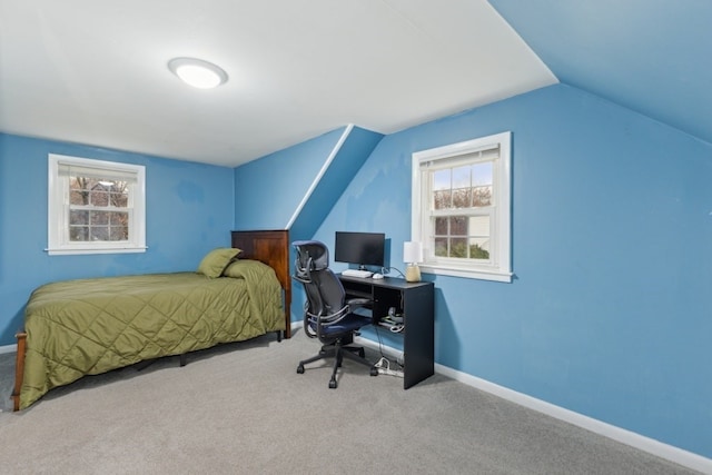 bedroom with lofted ceiling and light colored carpet