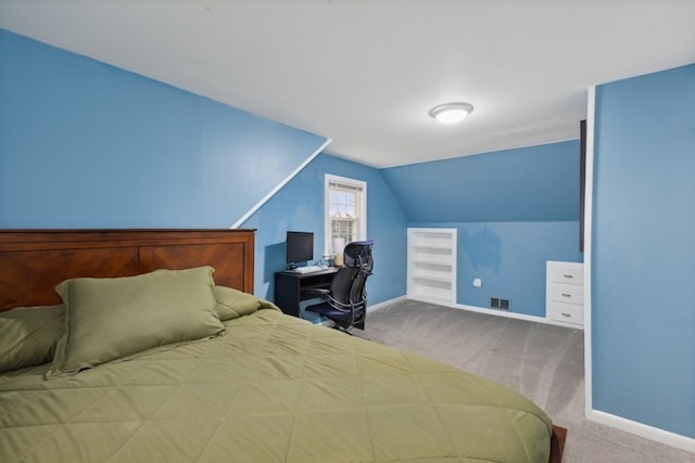 carpeted bedroom with lofted ceiling