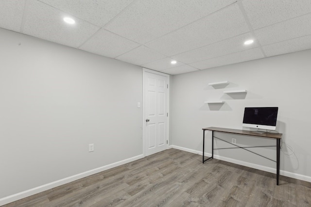 interior space with hardwood / wood-style flooring and a drop ceiling