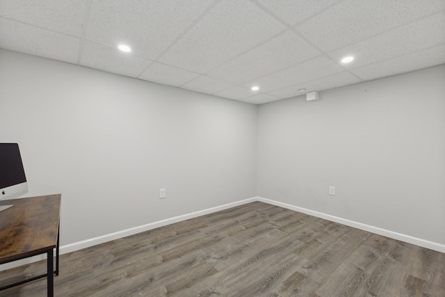 interior space featuring a paneled ceiling and hardwood / wood-style floors