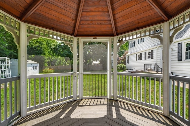 unfurnished sunroom featuring wood ceiling and beam ceiling