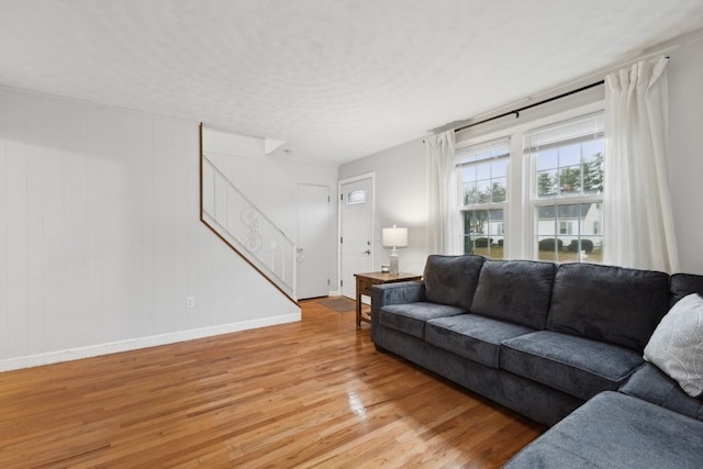 living room with light hardwood / wood-style flooring and a textured ceiling