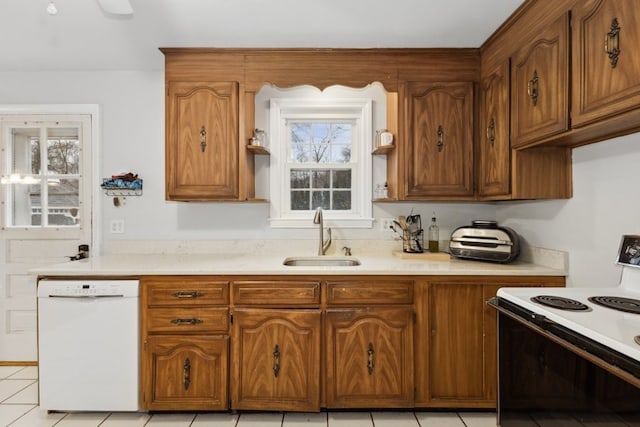 kitchen with range with electric stovetop, plenty of natural light, sink, and white dishwasher