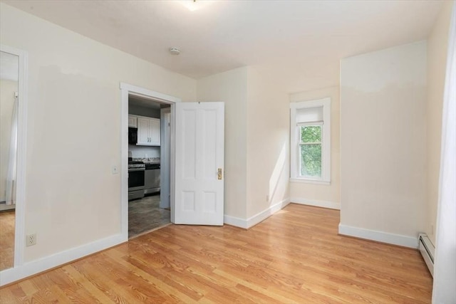29 Balcomb St Unit 29, Salem, MA 01970 - spare room featuring a baseboard radiator, light wood-style flooring, baseboards, and a smoke detector