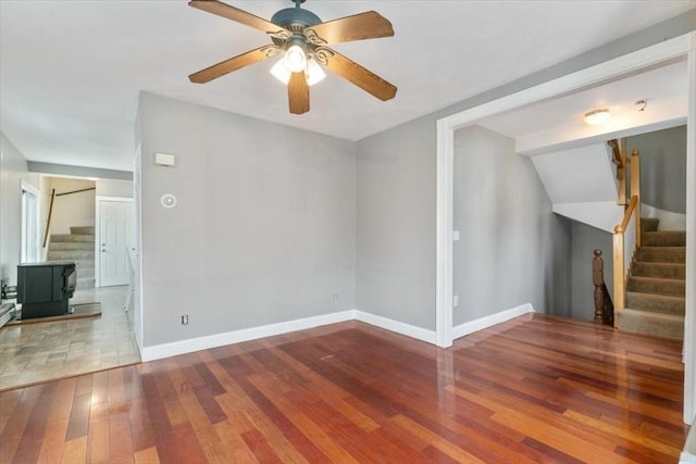 29 Balcomb St Unit 29, Salem, MA 01970 - unfurnished living room featuring stairs, hardwood / wood-style floors, baseboards, and a wood stove