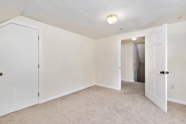 29 Balcomb St Unit 29, Salem, MA 01970 - unfurnished bedroom with light colored carpet, vaulted ceiling, and baseboards