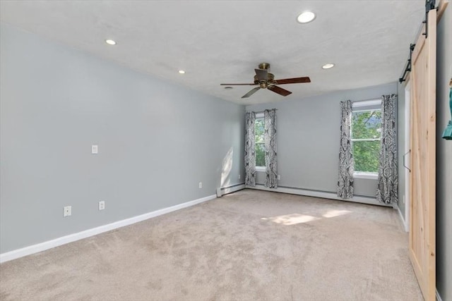 29 Balcomb St Unit 29, Salem, MA 01970 - empty room featuring a barn door, healthy amount of natural light, recessed lighting, carpet, and baseboards