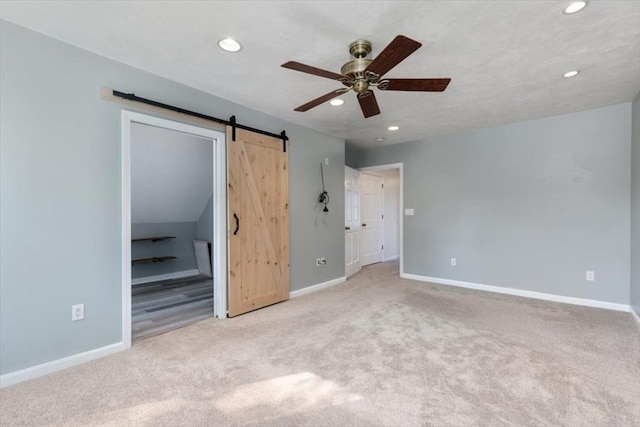 29 Balcomb St Unit 29, Salem, MA 01970 - unfurnished bedroom featuring a barn door, carpet flooring, recessed lighting, baseboards, and a ceiling fan