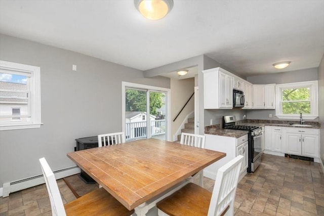 29 Balcomb St Unit 29, Salem, MA 01970 - kitchen with stainless steel range with gas cooktop, black microwave, stone finish flooring, a sink, and white cabinets