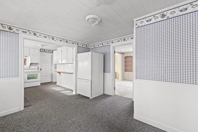 kitchen featuring white cabinetry, white refrigerator, stove, and dark carpet