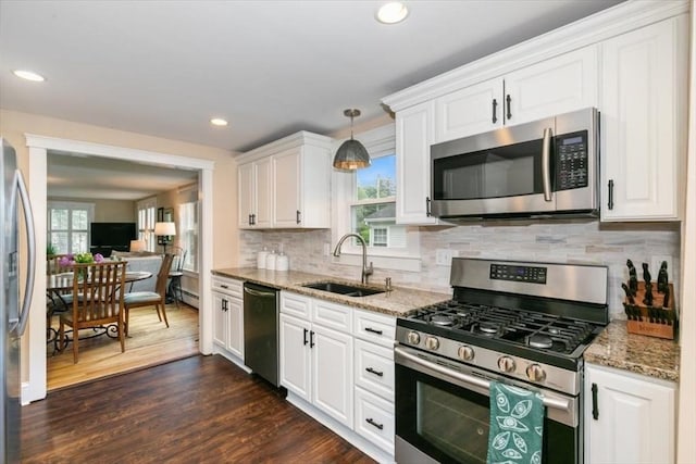 38 Pasho St, Andover, MA 01810 - kitchen with appliances with stainless steel finishes, white cabinetry, light stone countertops, backsplash, and recessed lighting