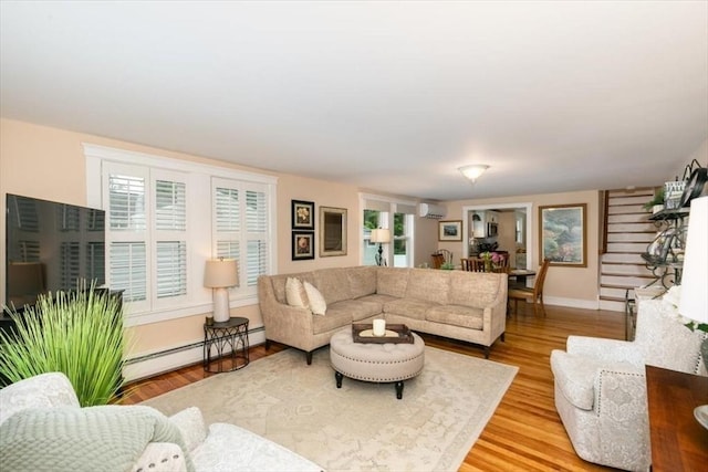 38 Pasho St, Andover, MA 01810 - living room featuring a baseboard radiator, a wall unit AC, and wood finished floors