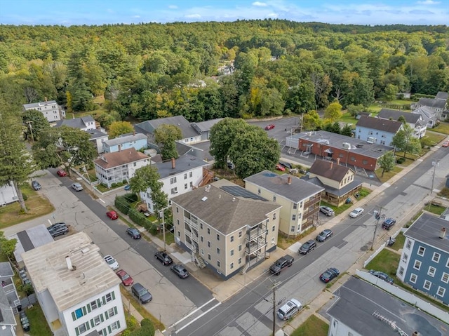 drone / aerial view with a wooded view