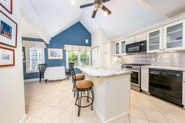 38 Gold Leaf, Mashpee, MA 02649 - kitchen featuring black appliances, light tile patterned flooring, a kitchen bar, light stone countertops, and high vaulted ceiling