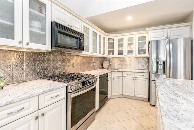 38 Gold Leaf, Mashpee, MA 02649 - kitchen with black appliances, light tile patterned floors, white cabinetry, backsplash, and recessed lighting