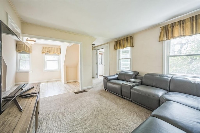 living area with light colored carpet, baseboards, and ornamental molding