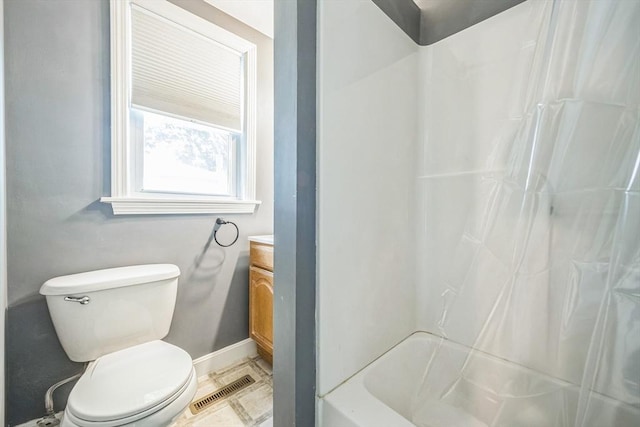 bathroom featuring baseboards, vanity, and toilet