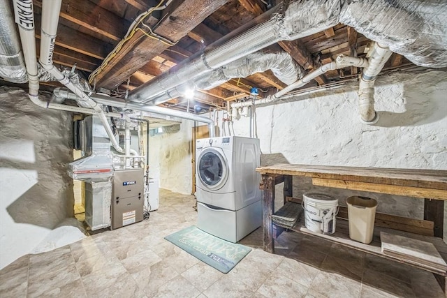 unfinished basement featuring washing machine and clothes dryer