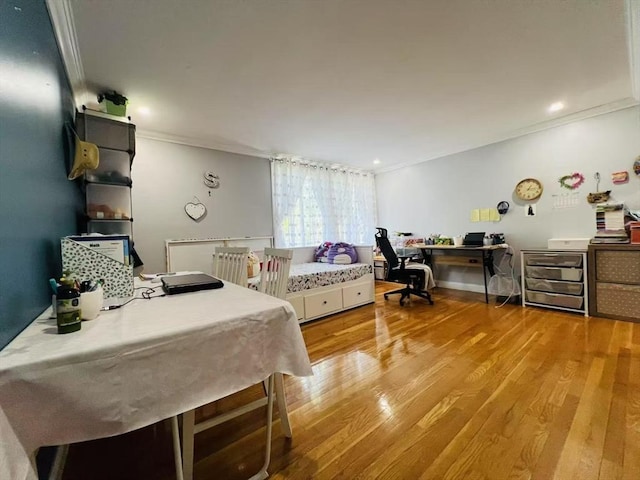 bedroom with crown molding and light wood-style flooring
