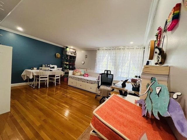 bedroom with crown molding and wood finished floors