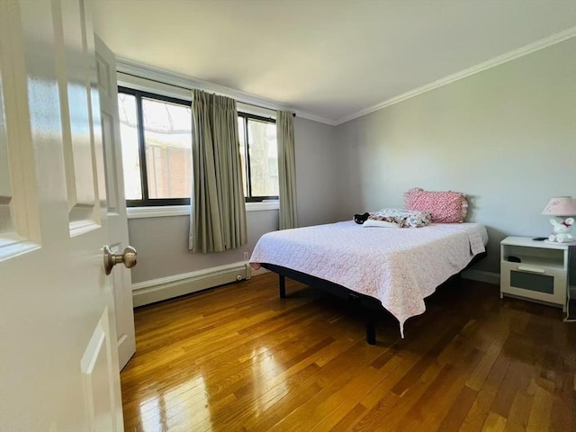 bedroom featuring crown molding, hardwood / wood-style floors, and a baseboard radiator