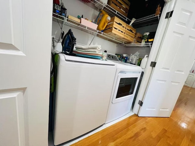 laundry room with light wood-style floors and independent washer and dryer