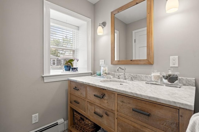 bathroom featuring a baseboard heating unit and vanity