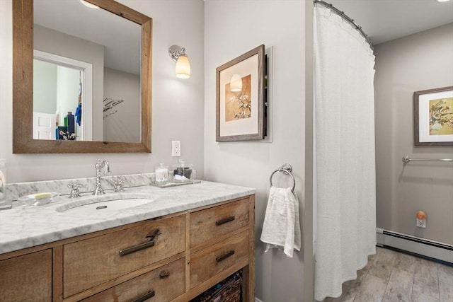 full bath featuring vanity and a baseboard heating unit