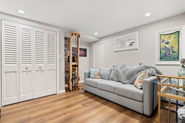 living area featuring light wood-type flooring and recessed lighting