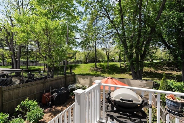 wooden terrace with fence and grilling area