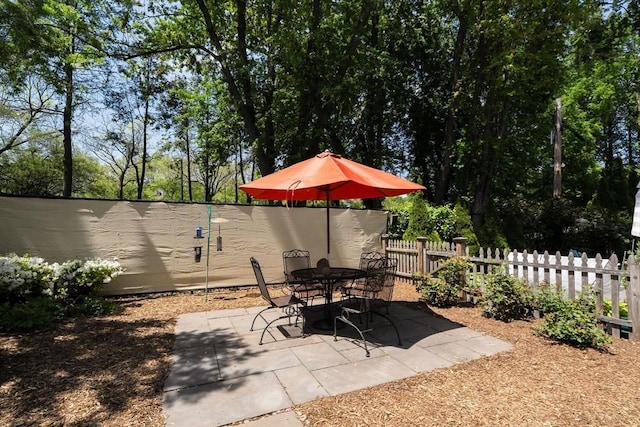 view of patio with fence and outdoor dining space