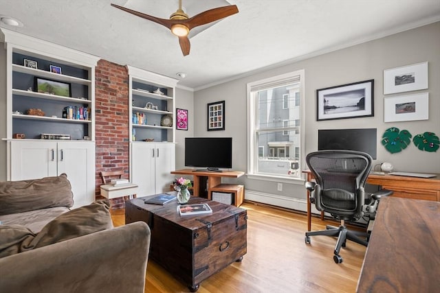 office area with light wood-style flooring, crown molding, a ceiling fan, built in features, and baseboards