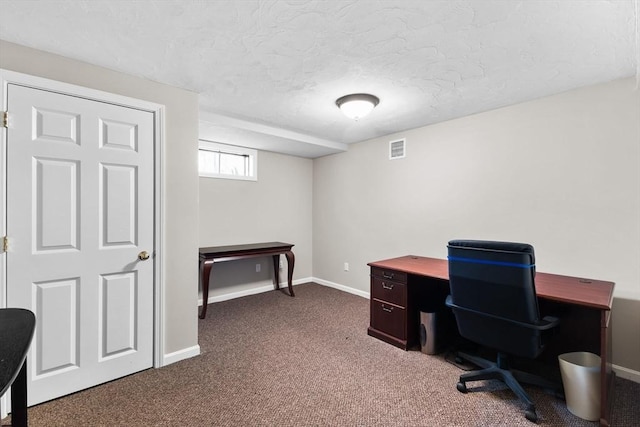 office area featuring baseboards, a textured ceiling, visible vents, and dark carpet