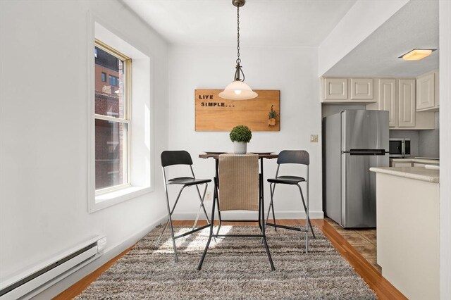 dining room featuring light wood-style flooring and baseboard heating