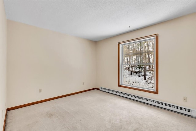 unfurnished room featuring a baseboard radiator, light colored carpet, and a textured ceiling