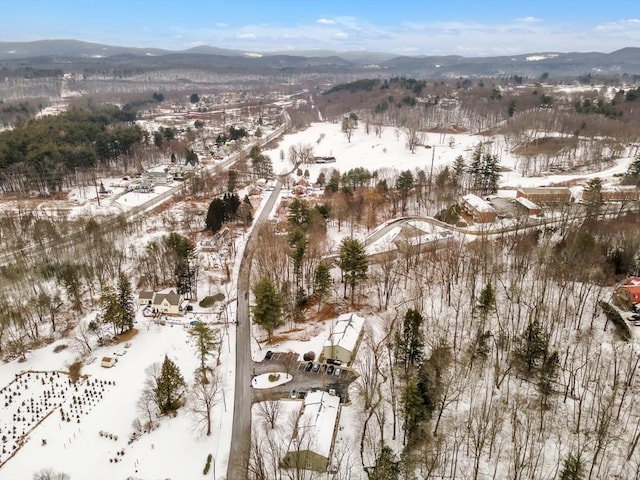 snowy aerial view featuring a mountain view