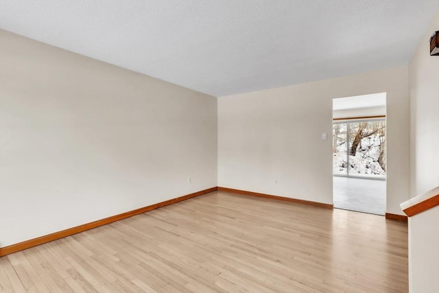 spare room with light hardwood / wood-style floors