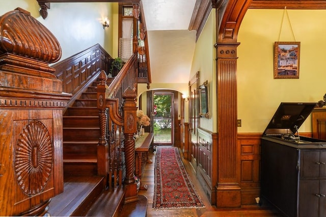 staircase with hardwood / wood-style flooring and a towering ceiling