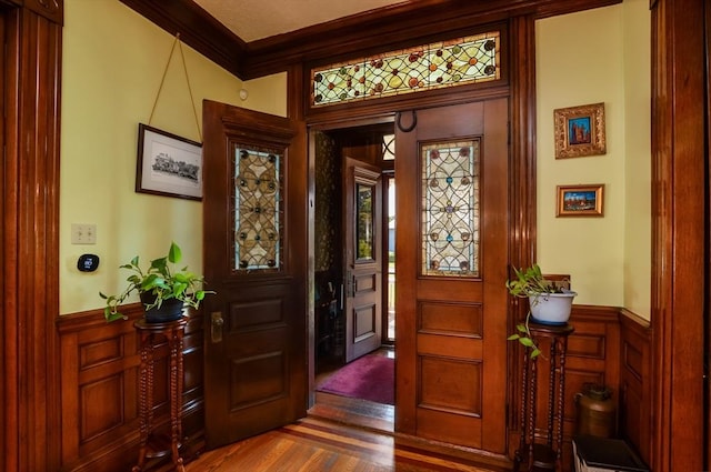 entryway featuring dark hardwood / wood-style flooring and ornamental molding