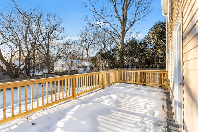 snow covered deck featuring a fenced backyard